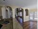 Bright living room with hardwood floors, arched doorways and large windows at 4520 Mossey Dr, Lithonia, GA 30038