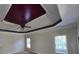 Main bedroom featuring a tray ceiling, fan and large windows at 4520 Mossey Dr, Lithonia, GA 30038
