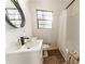 Bright bathroom featuring a modern vanity, stylish fixtures, and a window offering natural light at 4776 Ballew Dr, Powder Springs, GA 30127