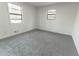 Bright bedroom with plush carpet, large windows, and a clean, minimalist design at 4776 Ballew Dr, Powder Springs, GA 30127