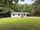 Charming single-story home with a well-manicured lawn and inviting red front door at 4776 Ballew Dr, Powder Springs, GA 30127