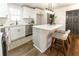 Modern white kitchen featuring an island with bar seating and stainless steel appliances at 4776 Ballew Dr, Powder Springs, GA 30127