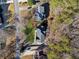 High angle aerial view of homes surrounded by mature trees, manicured lawns, and neighborhood streets at 5956 Henley Dr, Powder Springs, GA 30127