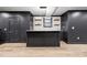 Finished basement with a modern bar, accent lighting, and a door to the outside at 5956 Henley Dr, Powder Springs, GA 30127