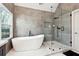 Bathroom featuring a sleek shower and a soaking tub with luxurious black hardware and a window view at 5956 Henley Dr, Powder Springs, GA 30127