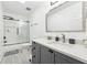A full bathroom with a shower-tub, dark gray vanity and granite countertop at 5956 Henley Dr, Powder Springs, GA 30127