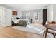 Well-lit bedroom featuring a large window, a table with chairs, and wood floors at 5956 Henley Dr, Powder Springs, GA 30127