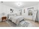 Bright bedroom features a large window, modern decor, and light hardwood floors at 5956 Henley Dr, Powder Springs, GA 30127