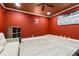 Bonus room or media room featuring a ceiling fan, red walls and a grey floor at 5956 Henley Dr, Powder Springs, GA 30127