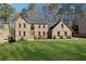 Brick two-story home with a well manicured lawn and mature trees at 5956 Henley Dr, Powder Springs, GA 30127