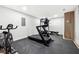 Home gym with a fan, a treadmill, an exercise bike, and workout benches at 5956 Henley Dr, Powder Springs, GA 30127