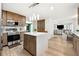 Bright, modern kitchen featuring stainless steel appliances, kitchen island, and hardwood floors at 5956 Henley Dr, Powder Springs, GA 30127