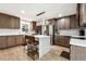 Kitchen featuring stainless steel appliances, central island, breakfast bar, and wood floors at 5956 Henley Dr, Powder Springs, GA 30127