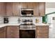 Kitchen featuring stainless steel appliances, custom cabinetry, and granite countertops at 5956 Henley Dr, Powder Springs, GA 30127