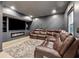 Modern living room with a large tv, fireplace, and a sectional couch at 5956 Henley Dr, Powder Springs, GA 30127