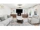 Elegant living room with a cozy fireplace, a wall-mounted television, and recessed lighting at 5956 Henley Dr, Powder Springs, GA 30127