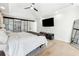 Spacious main bedroom with a ceiling fan, hardwood floors, and glass doors leading to the bathroom at 5956 Henley Dr, Powder Springs, GA 30127