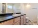 Well-lit bathroom featuring a large mirror, wood vanity and single sink, plus a shower at 6138 Raleigh Oaks Ct, Lithonia, GA 30058