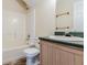 Bathroom featuring a shower-tub combo and a vanity with a sink and mirror at 6138 Raleigh Oaks Ct, Lithonia, GA 30058