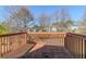 Wooden deck providing an outdoor space with a view of the backyard and surrounding trees at 6138 Raleigh Oaks Ct, Lithonia, GA 30058