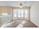 Living room showing bay window, ceiling fan, and large carpeted area at 6138 Raleigh Oaks Ct, Lithonia, GA 30058