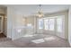 Living room showing carpet, large bay window, and ceiling fan at 6138 Raleigh Oaks Ct, Lithonia, GA 30058