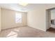 Bedroom featuring neutral paint, a window providing natural light, and carpeted floors at 6138 Raleigh Oaks Ct, Lithonia, GA 30058