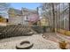Beautiful backyard featuring a stone patio with a fire pit, tiered retaining walls, and lush greenery, creating a serene retreat at 616 Redwood Ln, Canton, GA 30114