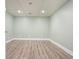 An empty basement room featuring waterproofed flooring, recessed lights, and fresh paint ready for customization at 616 Redwood Ln, Canton, GA 30114