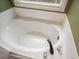 A relaxing soaking tub situated under a window, offering a serene bathing experience at 616 Redwood Ln, Canton, GA 30114