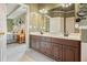 A spacious bathroom featuring double sinks and neutral tones adjacent to the bedroom at 616 Redwood Ln, Canton, GA 30114