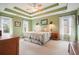 Spacious bedroom featuring tray ceilings and ample natural light from surrounding windows at 616 Redwood Ln, Canton, GA 30114