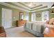 Serene green-painted bedroom with tray ceilings, windows, and carpeted floors at 616 Redwood Ln, Canton, GA 30114