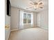 An airy bedroom with neutral walls features a ceiling fan and a large window at 616 Redwood Ln, Canton, GA 30114