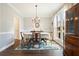 Elegant dining room with hardwood floors, a chandelier, and a large window for natural light at 616 Redwood Ln, Canton, GA 30114
