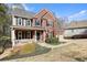 Charming two-story brick house with a welcoming porch, two-car garage, and well-maintained landscaping at 616 Redwood Ln, Canton, GA 30114