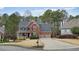 Charming two-story brick home featuring a two-car garage and covered front porch at 616 Redwood Ln, Canton, GA 30114