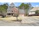 Beautiful two-story brick house with attached two-car garage, charming porch, and manicured front lawn at 616 Redwood Ln, Canton, GA 30114