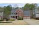 Charming two-story brick home with a covered front porch and attached two-car garage at 616 Redwood Ln, Canton, GA 30114