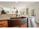 The kitchen island features a copper farmhouse sink, stainless steel appliances and granite countertop at 616 Redwood Ln, Canton, GA 30114