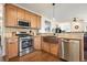 Bright kitchen featuring stainless steel appliances, hardwood floors and wooden cabinetry at 616 Redwood Ln, Canton, GA 30114