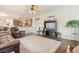 Open-concept living room with hardwood floors and a ceiling fan leading to the kitchen at 616 Redwood Ln, Canton, GA 30114