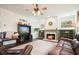 Bright living room featuring a fireplace, built-in shelves, hardwood floors and ample seating at 616 Redwood Ln, Canton, GA 30114