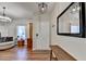 Welcoming foyer with hardwood floors, a large mirror, and a view into the cozy living area at 6574 Barker Station Walk, Sugar Hill, GA 30518