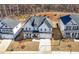 An elevated view of a two-story white home with a two-car garage and pristine landscaping at 929 Keystone Dr, Woodstock, GA 30188