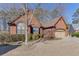 Traditional brick home featuring well-maintained landscaping, a two-car garage, and mature trees at 1615 Creek Pointe Cir, Lawrenceville, GA 30043