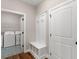 Mudroom with white storage bench and entry to laundry room at 1847 Davis Mill N Rd, Dallas, GA 30157