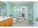 Bright bathroom with double sinks, vanity, and a connecting door to the closet at 977 Forest Knoll Ct, Lithia Springs, GA 30122