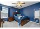 Cozy bedroom with a comfortable bed, ceiling fan, and a calming blue color scheme at 977 Forest Knoll Ct, Lithia Springs, GA 30122