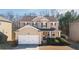 Charming two-story home featuring a welcoming front porch, attached garage, and well-maintained landscaping at 977 Forest Knoll Ct, Lithia Springs, GA 30122